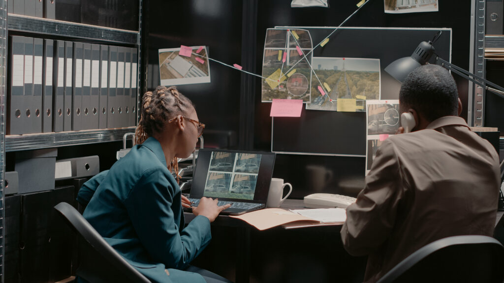 Team of detectives analyzing surveillance records